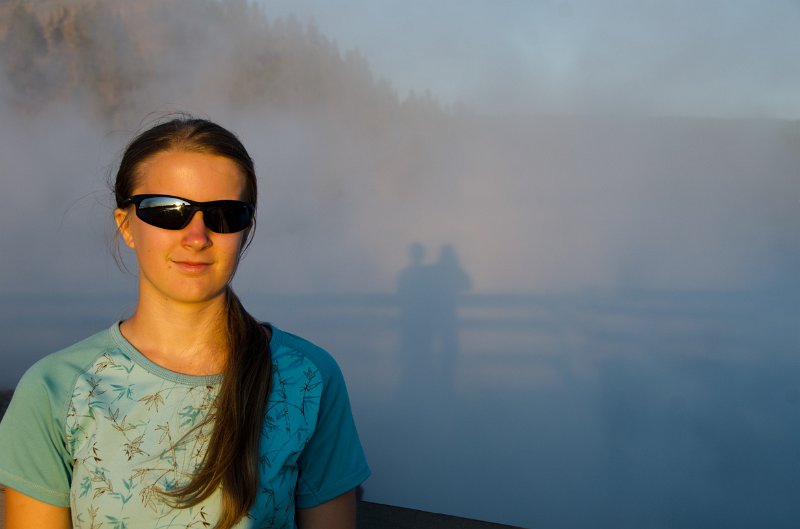 _DSC7334.jpg - Teagan silhouetted by the setting sun in the steam of Excelsior Geyser